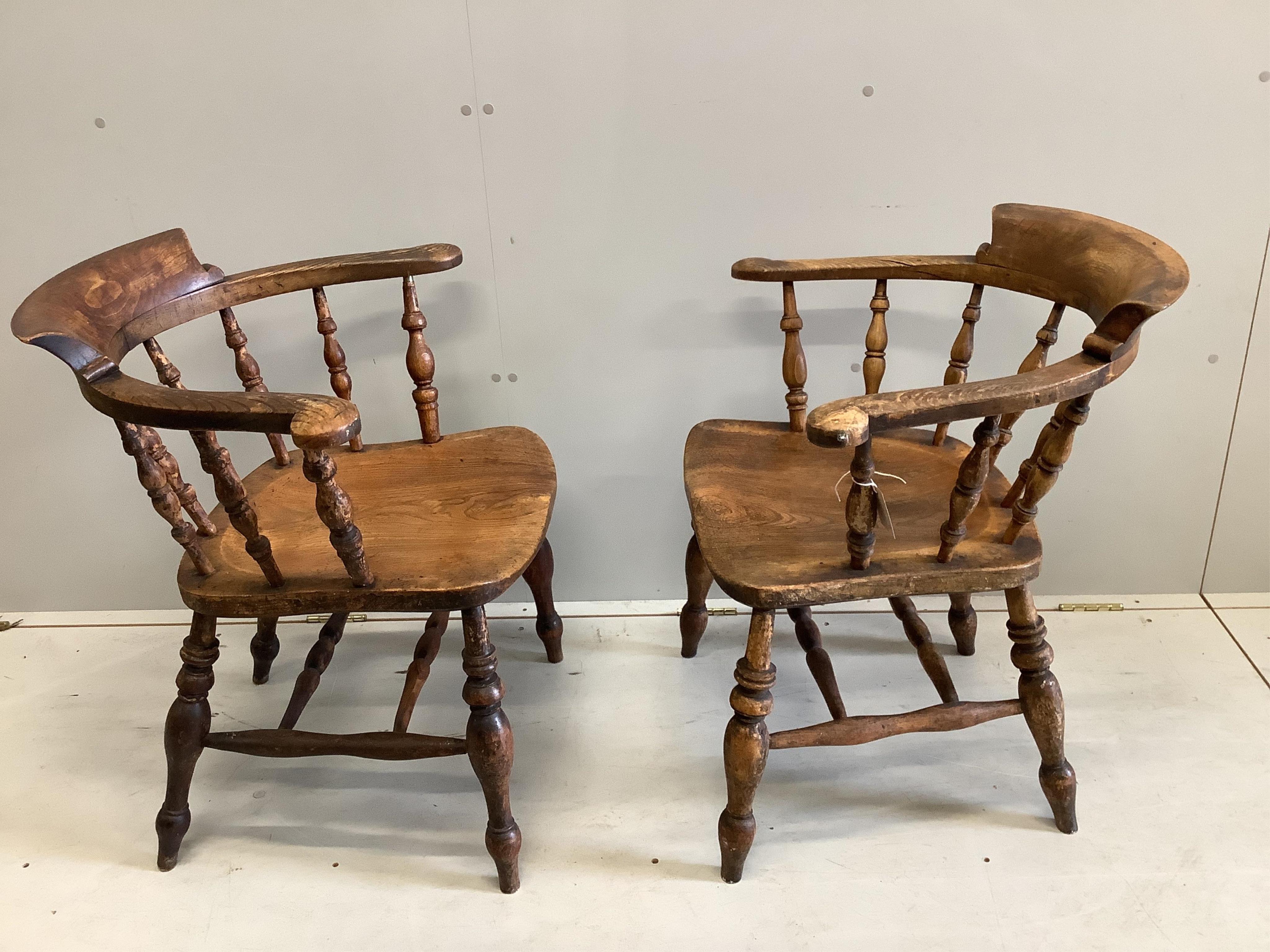 A near pair of Victorian elm and beech Windsor smoker's bow chairs, width 63cm, depth 45cm, height 77cm. Condition - fair